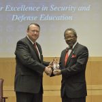Dr. Griffith receives the Perry Award from Director Wilkins